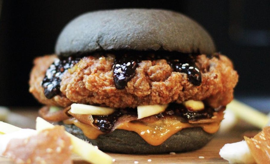 The limited-time Rojak Burger includes Rojak sauce (shrimp paste), pickled guava, rempenyet (Malay crackers), and fried chicken thigh. This unlikely combination rewards the adventurous with a surprisingly delicious blend of umami-rich flavors.